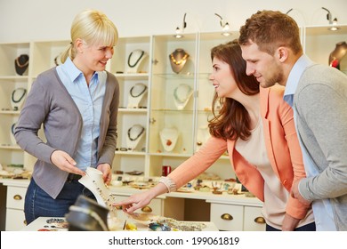 Woman Talking To A Salesperson At Jeweler Store