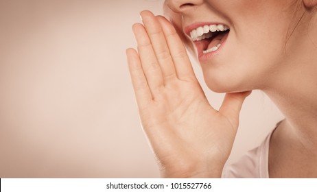 Woman Talking To Someone Gossip And Rumors With Hand Close To Lips.