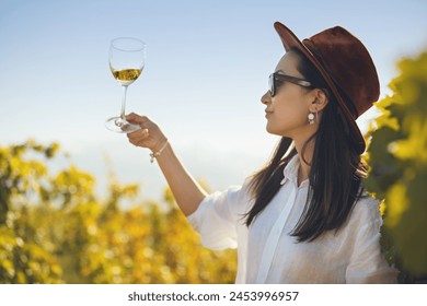 Woman Tasting White Wine in Glass on Plantation of Vineyard - Powered by Shutterstock