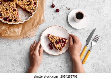 Woman with tasty cherry pie and cup of coffee on light background - Powered by Shutterstock