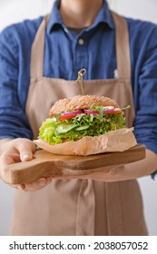 Woman With Tasty Vegan Burger, Closeup