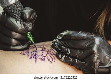 Woman Tattoo Artist Doing Tattoo In Studio, Making Tattoo On Body. Closeup