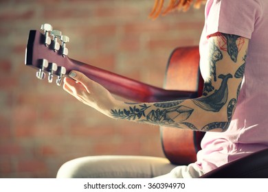 Woman and tattoo playing