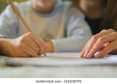 Woman teach son how to do homework at home,school child family education - Powered by Shutterstock