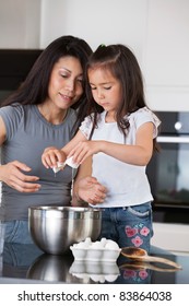 Woman Teaching Child To Prepare Dough With Healthy Ingredients