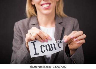Woman tearing up " I Can't " sign 