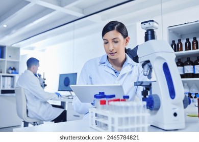 Woman, technician and medical research for covid 19, vaccine and tablet with lab equipment for pharma innovation. Female person, scientist and tech in healthcare for chemistry in forensic for results - Powered by Shutterstock