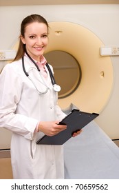 Woman Technologist With CT Scan Machine In Hospital