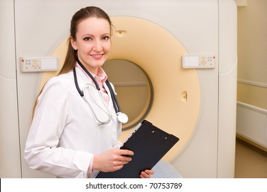 Woman Technologist With CT Scan Machine In Hospital