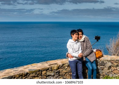 Woman And Teen Doing Selfie Near The Sea. Concept Of Happiness And Inspiration Of Travel