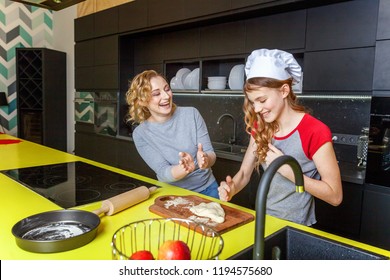 Woman and teenage girl preparing dough, bake homemade apple pie in kitchen. Happy family mother and daughter cooking healthy food at home and having fun. Household, teamwork helping, maternity concept