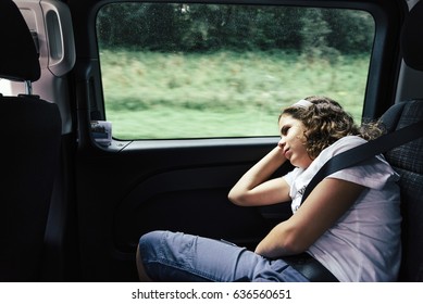 Woman Teenager Sleeping In The Backseat Of A Car On A Trip.