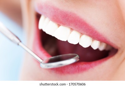 Woman Teeth And A Dentist Mouth Mirror 