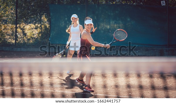 Woman in a tennis\
double on a sunny day