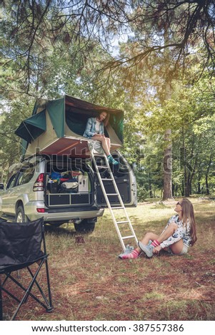 Similar – Women resting and talking lying in tent over car