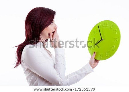 Woman with terrified face  holding big green clock