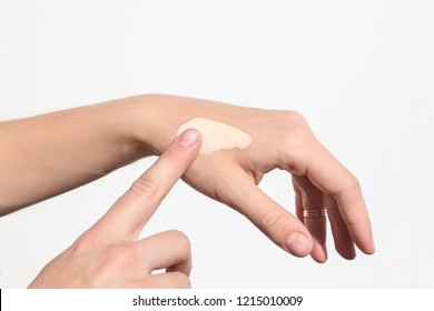 Woman Testing Foundation Tone On Hand, Closeup