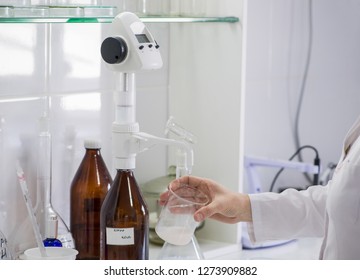 woman testing samples of dairy products in the laboratory. test laboratory of a milk factory - Powered by Shutterstock