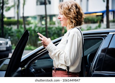 Woman Texting Before Getting Into The Car