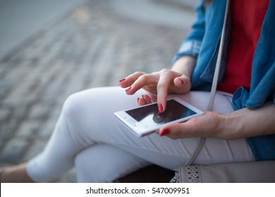 Woman texting. Closeup young happy smiling cheerful beautiful woman girl looking at mobile cell phone reading sending sms isolated cityscape outdoor background.