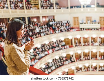 A woman in the theater watches the performance - Powered by Shutterstock