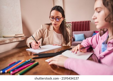 Woman Therapist Drawing At The Paper While Telling To Her Teen Patient About Art Therapy