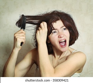 Woman With Thick Brown Tangled Hair Try To Comb Hairs But Fail