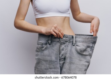 Diet Woman Taking Off Her Pants Stock Photo (Edit Now) 668497699