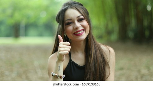 
Woman Thinking About Decision, Nodding Yes In Affirmation With Thumb Up