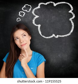 Woman Thinking Blackboard Concept. Pensive Girl Looking At Thought Bubble On Chalkboard / Blackboard Texture Background. Mixed Race Asian Chinese / Caucasian Student.