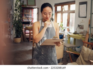 Woman, thinking or clipboard in pottery studio, ceramic small business or Asian art workshop on class schedule. Mud, craft or designer worker with clay vision, ideas or innovation on paper documents - Powered by Shutterstock