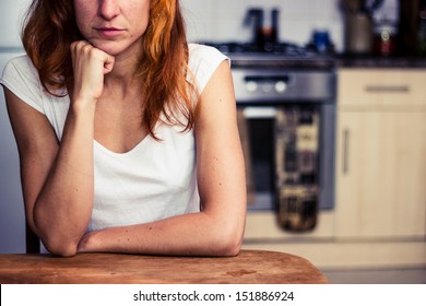 Woman is thinking in her kitchen