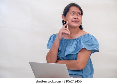 A Woman Thinking, A Tab On Her Lap.