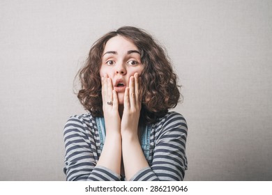 The woman thought, sad, thinking, emotions, fear. On a gray background. - Shutterstock ID 286219046