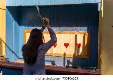 Woman Throwing An Axe At Target For Fun