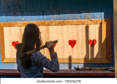 Woman Throwing An Axe At Target For Fun