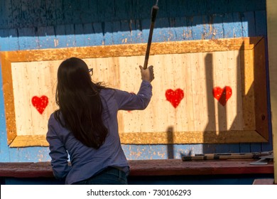 Woman Throwing An Axe At Target For Fun