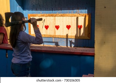 Woman Throwing An Axe At Target For Fun