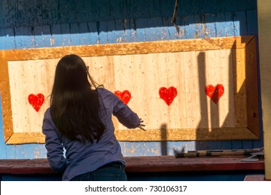 Woman Throwing An Axe At Target For Fun