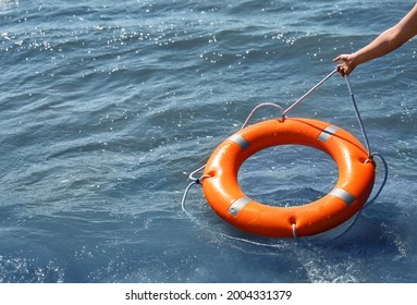 Woman Throwing Lifebuoy Ring On Water Stock Photo 2004331379 | Shutterstock