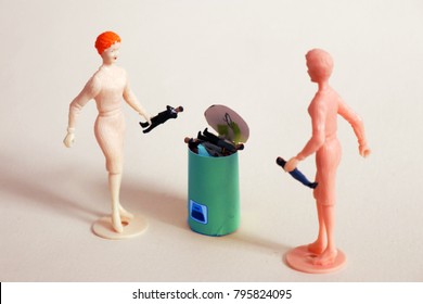 Woman Throws Tiny Man In A Trash Can.  Concept Of Ending Bad Relationships Or Ditching A Bad Boss. Breakup Or Divorce. Concept Of Employment Or Romantic Rejection. Frustration With Online Dating. 