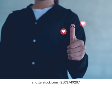 woman thumbs up showing happy smiley face and red heart emoticon, think positive, customer review, assessment, good mood, world mental health day. - Powered by Shutterstock