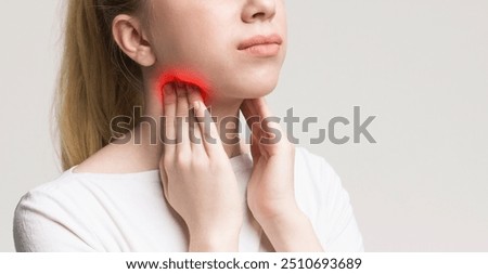 Woman with thyroid gland problem, touching her neck, closeup, panorama