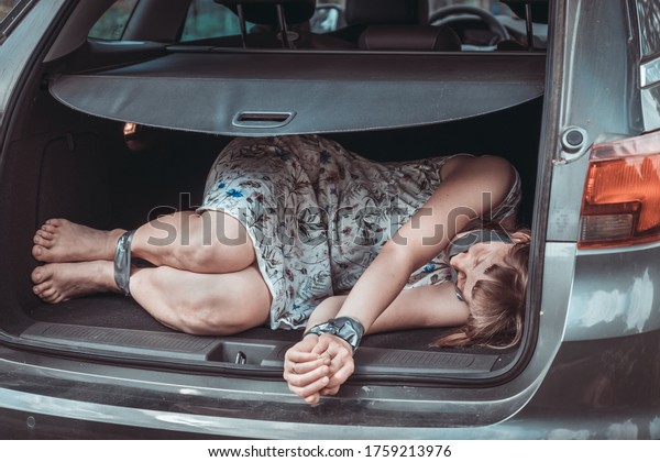 
Woman with tied hands inside car trunk -
kidnapping concept