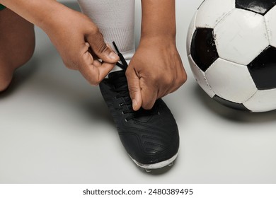 A woman ties her soccer cleats before a game. - Powered by Shutterstock