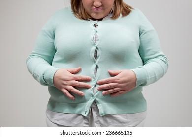 woman with tight clothing worried about weight gain.