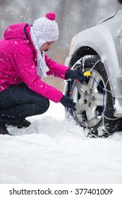 Woman With Tire Chains Car Snow Breakdown