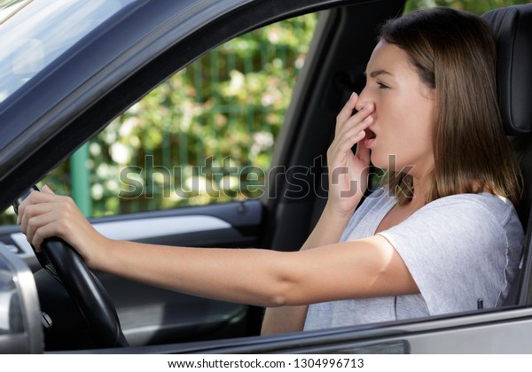 woman tired of heat in a\
car in summer