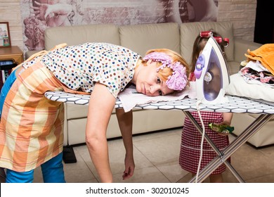 Woman Tired Ironed Clothes And Lay Down On The Ironing Board