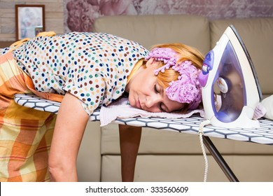 Woman Tired Ironed Clothes And Lay Down On The Ironing Board